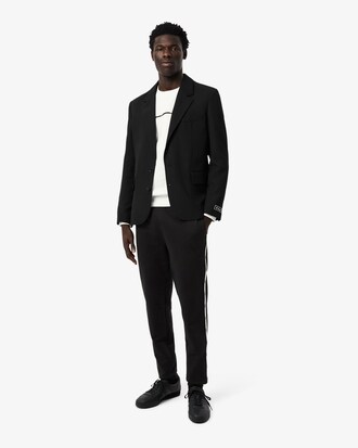 Pantalon de surv&ecirc;tement liser&eacute;s griff&eacute;s