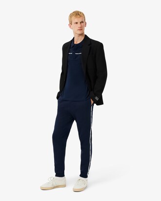 Pantalon de surv&ecirc;tement liser&eacute;s griff&eacute;s