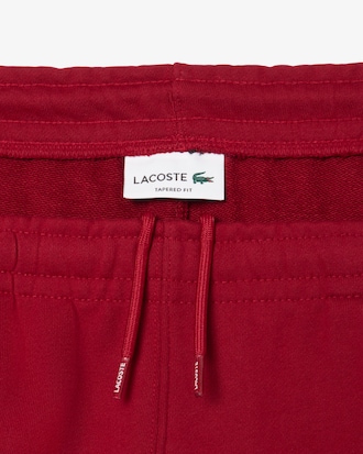 Pantalon de surv&ecirc;tement liser&eacute;s griff&eacute;s