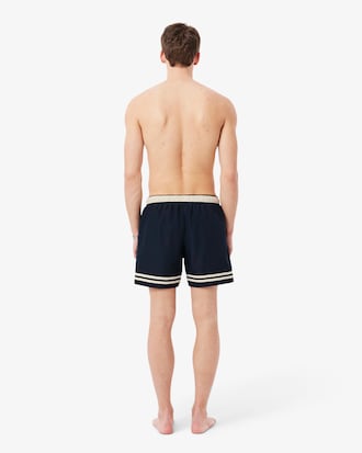 Short de ba&ntilde;o Lacoste con rayas en contraste de largo medio