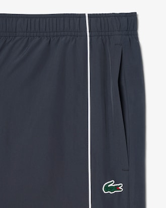 Pantal&oacute;n de ch&aacute;ndal deportivo hidr&oacute;fugo con ribete en contraste