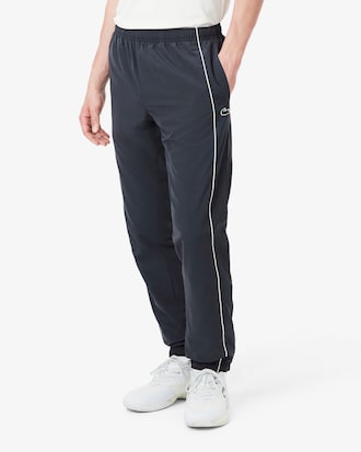 Pantal&oacute;n de ch&aacute;ndal deportivo hidr&oacute;fugo con ribete en contraste