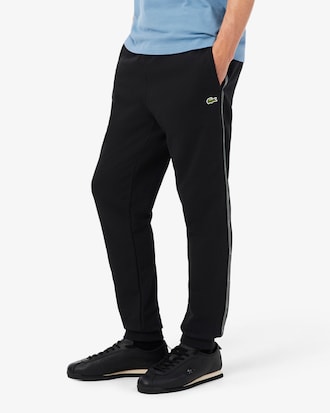 Pantal&oacute;n de ch&aacute;ndal con raya y logotipo
