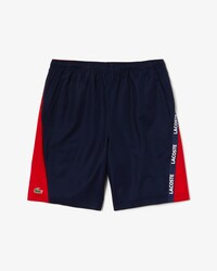 Pantal&oacute;n corto de hombre Lacoste SPORT bicolor con franjas distintivas