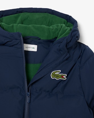 Chaqueta acolchada con capucha y cocodrilo bordado