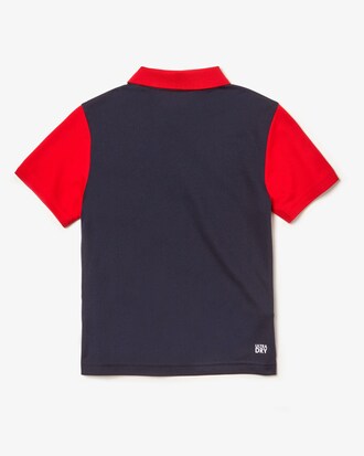 Polo de niño Lacoste SPORT en piqué color block transpirable con franja distintiva