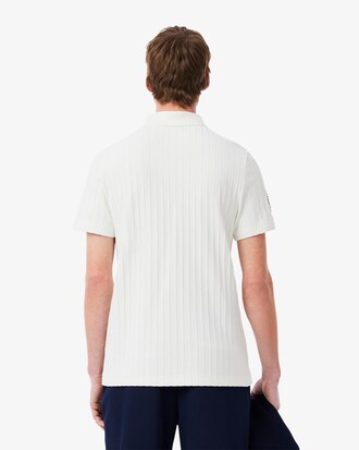 Polo de tenis cl&aacute;sico con insignia decorativa Ultra Dry