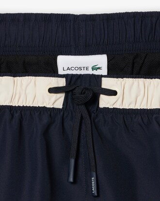 Short de ba&ntilde;o Lacoste con rayas en contraste de largo medio