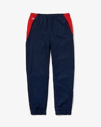 Pantal&oacute;n de deporte de hombre Lacoste SPORT color block con franjas distintivas