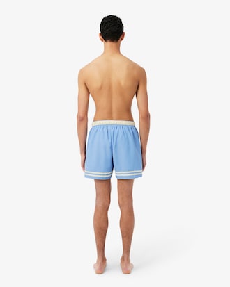 Short de ba&ntilde;o Lacoste con rayas en contraste de largo medio