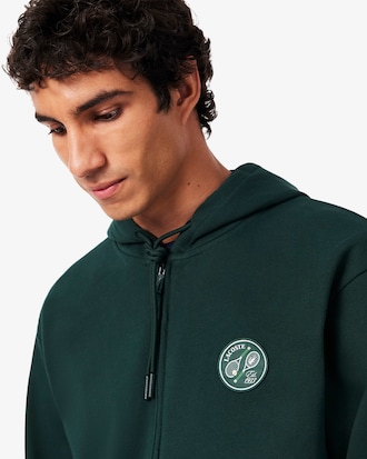 Sudadera con capucha y cremallera con insignia