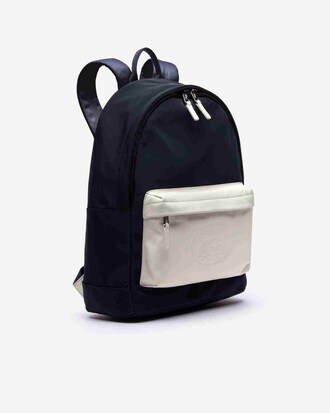 Sac à dos L.12.12 bicolore poche en cuir et marquage embossé