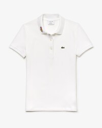 Polo da donna in mini piqu&eacute; elasticizzata slim fit con colletto con motivo Keith Haring